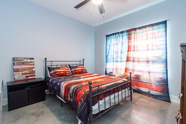 bedroom with ceiling fan and concrete flooring