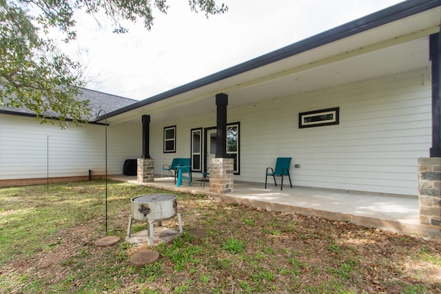 rear view of house featuring a porch