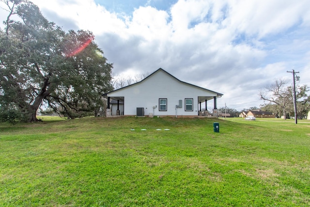 view of home's exterior with cooling unit and a lawn