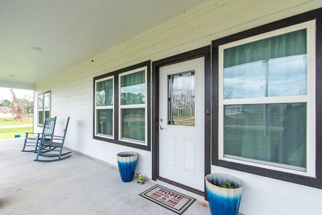 view of exterior entry with a porch