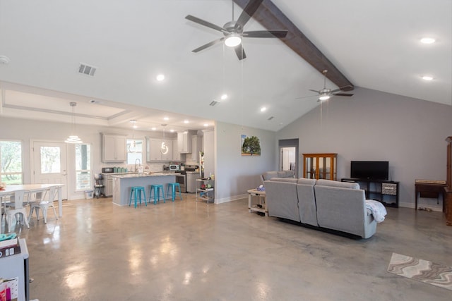 living room featuring beam ceiling, visible vents, finished concrete floors, ceiling fan, and baseboards