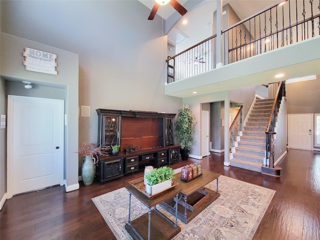 1904 Emerald Breeze Ct, Pearland, TX 77089 - living room with a ceiling fan, hardwood / wood-style floors, a high ceiling, stairs, and baseboards