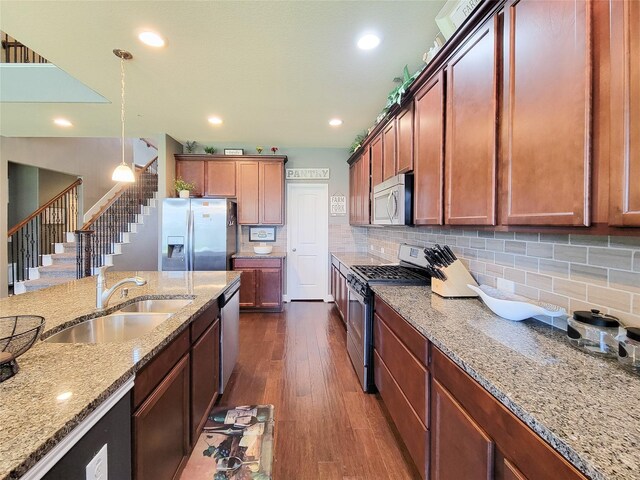 1904 Emerald Breeze Ct, Pearland, TX 77089 - kitchen with dark wood-type flooring, a sink, light stone countertops, and stainless steel appliances