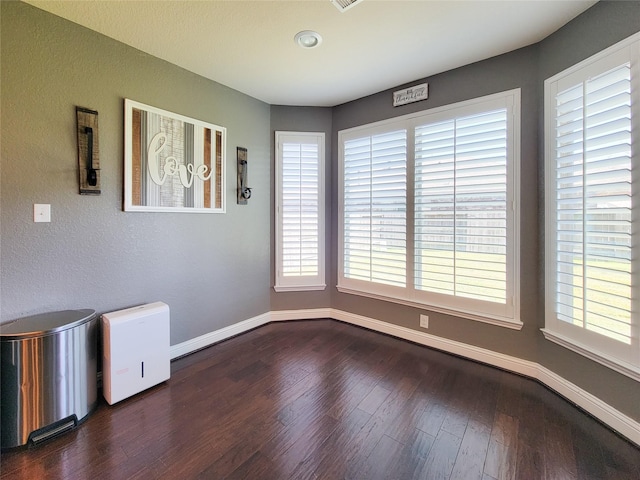 1904 Emerald Breeze Ct, Pearland, TX 77089 - unfurnished dining area with dark wood-style flooring and baseboards