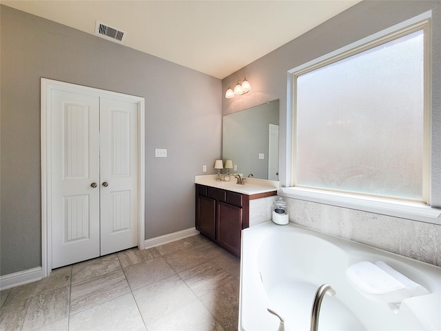 1904 Emerald Breeze Ct, Pearland, TX 77089 - full bathroom with vanity, visible vents, baseboards, and a garden tub
