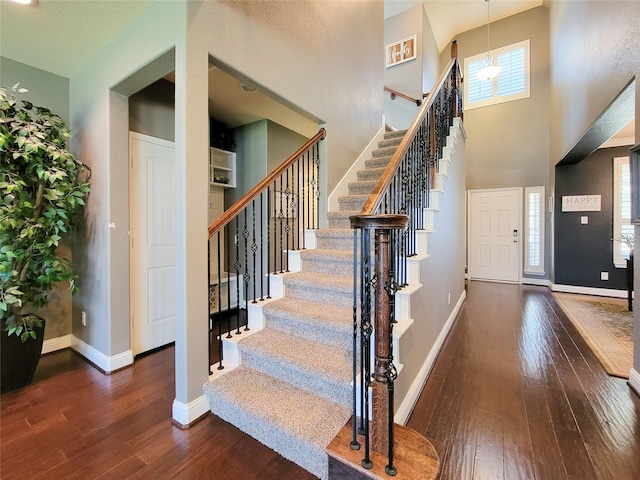 1904 Emerald Breeze Ct, Pearland, TX 77089 - foyer featuring a towering ceiling, baseboards, stairway, and hardwood / wood-style flooring