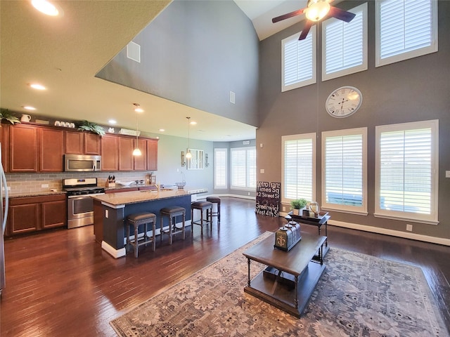 living room featuring visible vents, baseboards, recessed lighting, a ceiling fan, and dark wood-style flooring