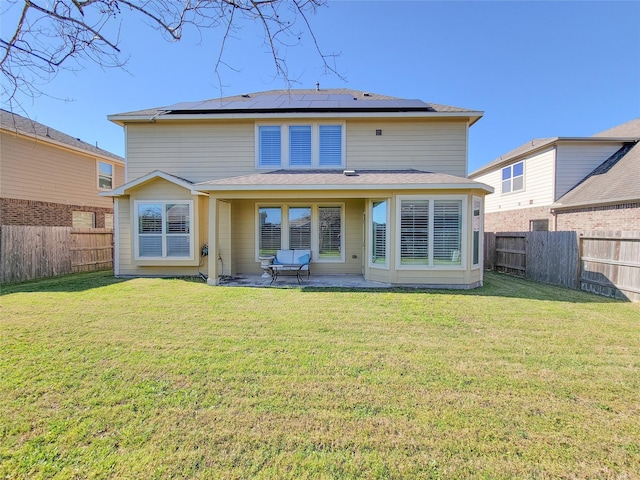 1904 Emerald Breeze Ct, Pearland, TX 77089 - rear view of property with a patio area, a fenced backyard, a lawn, and roof mounted solar panels