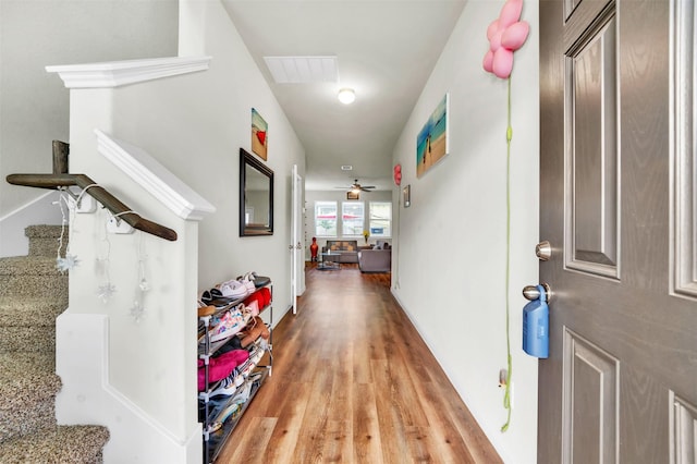 hall with wood finished floors and visible vents