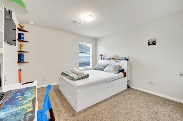 carpeted bedroom featuring visible vents and baseboards