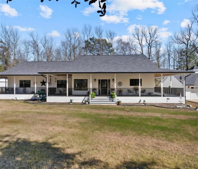 back of property featuring roof with shingles, a lawn, and ceiling fan