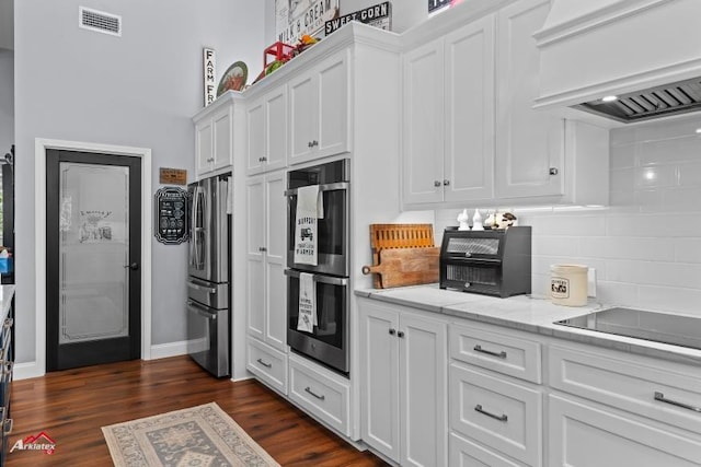6270 US Highway 259 N, Naples, TX 75568 - kitchen featuring visible vents, appliances with stainless steel finishes, premium range hood, and white cabinetry