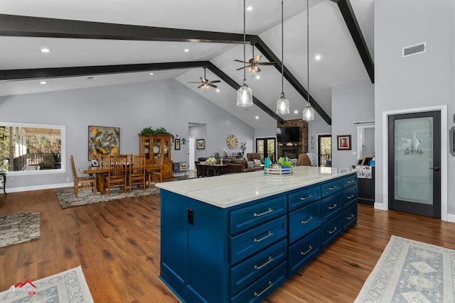 6270 US Highway 259 N, Naples, TX 75568 - kitchen featuring pendant lighting, blue cabinetry, visible vents, open floor plan, and a kitchen island