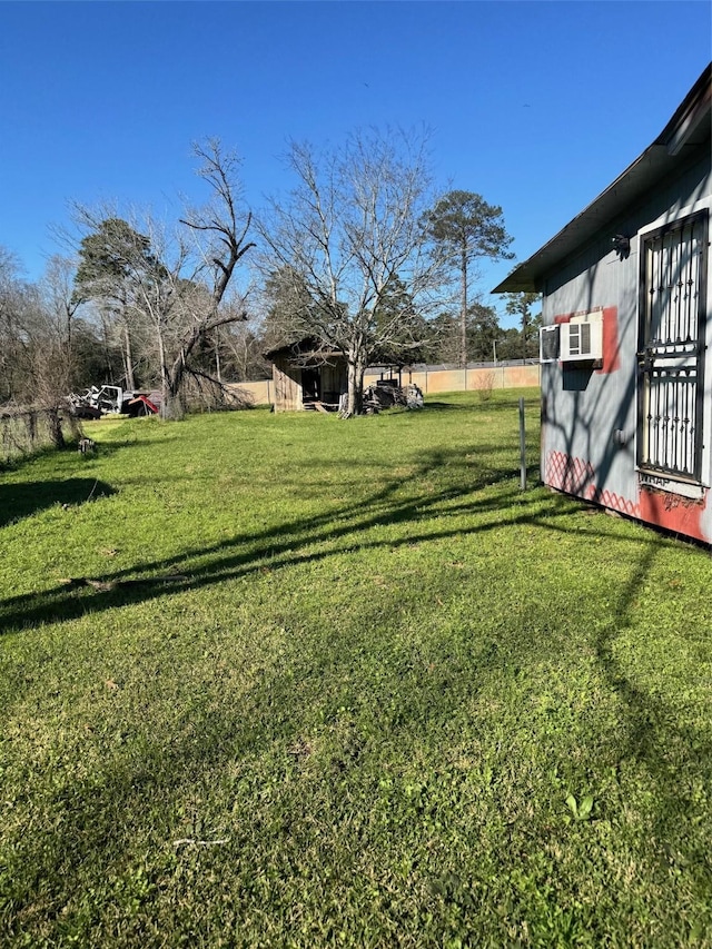 view of yard with an outdoor structure and fence