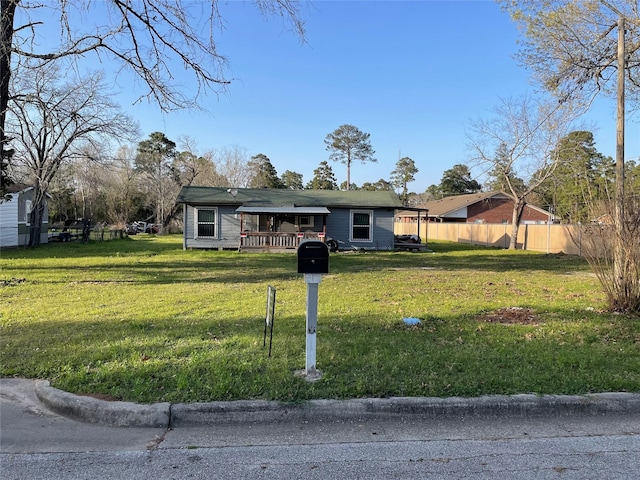single story home featuring a front lawn and fence