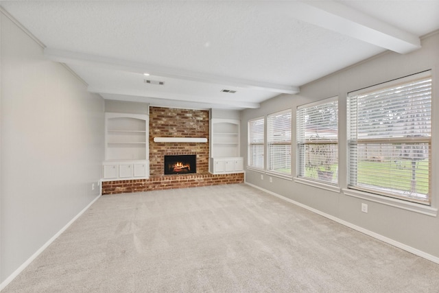 unfurnished living room featuring a textured ceiling, baseboards, and beamed ceiling