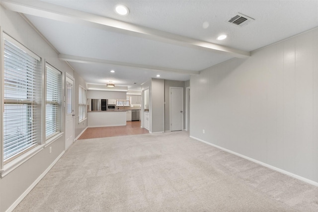 unfurnished living room featuring recessed lighting, visible vents, light carpet, beamed ceiling, and baseboards