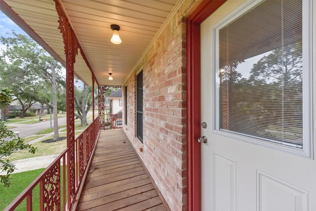 wooden terrace featuring covered porch