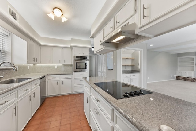 kitchen featuring light tile patterned floors, tasteful backsplash, white cabinets, appliances with stainless steel finishes, and a sink