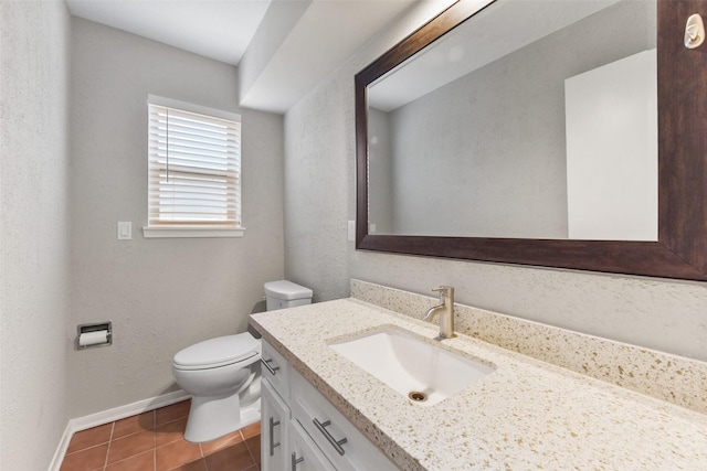 bathroom featuring a textured wall, tile patterned flooring, toilet, vanity, and baseboards