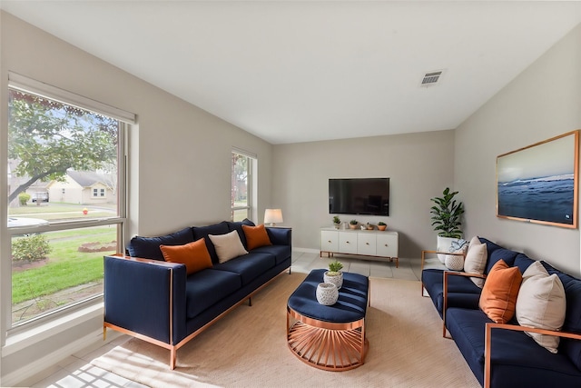 living room with visible vents, baseboards, and light tile patterned flooring