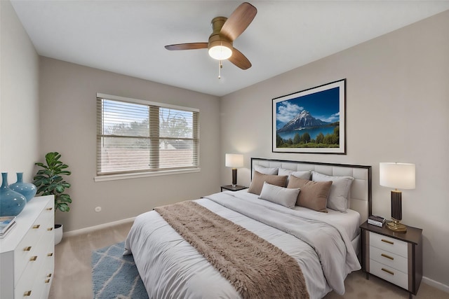 bedroom featuring baseboards, ceiling fan, and light colored carpet