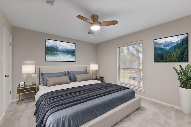 bedroom featuring light carpet, a ceiling fan, visible vents, and baseboards