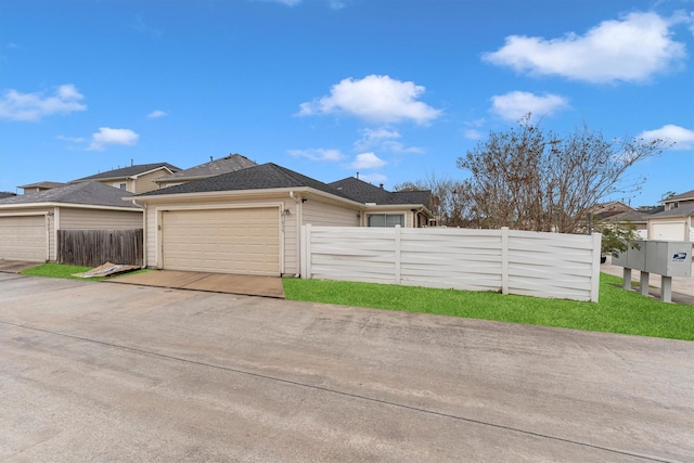 view of side of home featuring fence