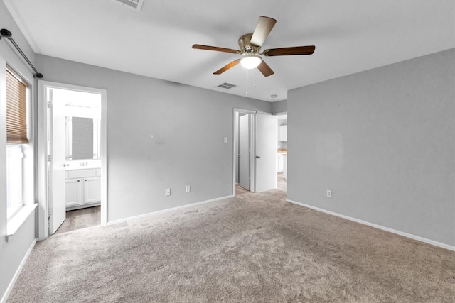 unfurnished bedroom featuring baseboards, visible vents, and light colored carpet