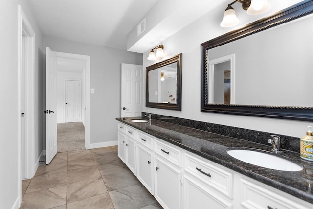 8014 Northbridge Cir, Spring, TX 77379 - bathroom with double vanity, baseboards, and a ceiling fan