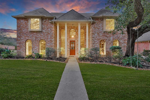 8014 Northbridge Cir, Spring, TX 77379 - neoclassical / greek revival house with a front yard, brick siding, and a shingled roof