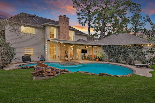 8014 Northbridge Cir, Spring, TX 77379 - rear view of property with a chimney, a lawn, an outdoor pool, and a patio area