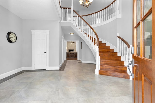 8014 Northbridge Cir, Spring, TX 77379 - entryway featuring stairway, baseboards, a chandelier, a fireplace, and a high ceiling