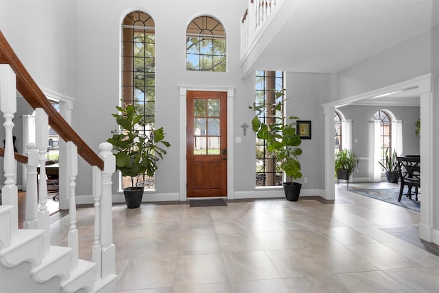 8014 Northbridge Cir, Spring, TX 77379 - tiled foyer entrance with stairs, a high ceiling, and baseboards