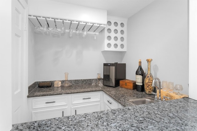 8014 Northbridge Cir, Spring, TX 77379 - kitchen with a sink, white cabinets, and dark stone countertops