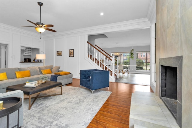 8014 Northbridge Cir, Spring, TX 77379 - living area featuring ornamental molding, stairway, light wood-style floors, ceiling fan, and a chandelier