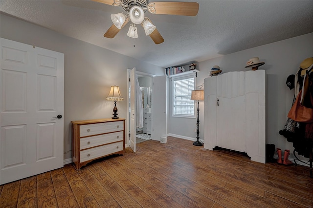 bedroom featuring a textured ceiling, ceiling fan, dark wood finished floors, and baseboards