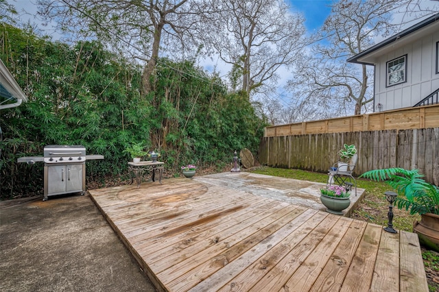 deck with area for grilling and fence