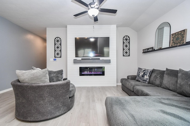 915 Acorn Trail Pl, Tomball, TX 77375 - living area with wood finished floors, ceiling fan, a fireplace, baseboards, and lofted ceiling