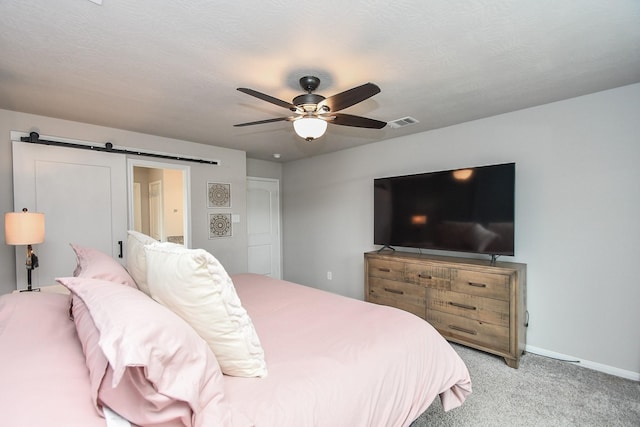 915 Acorn Trail Pl, Tomball, TX 77375 - bedroom featuring light colored carpet, a barn door, ceiling fan, and baseboards