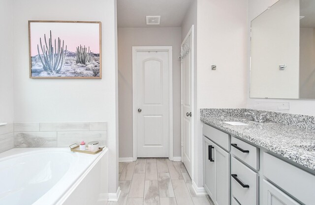915 Acorn Trail Pl, Tomball, TX 77375 - full bathroom with a bath, vanity, and baseboards