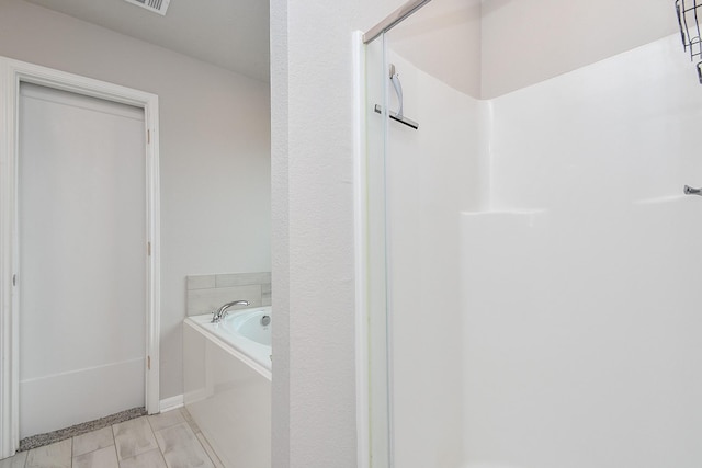 915 Acorn Trail Pl, Tomball, TX 77375 - bathroom featuring a bath, a shower, and baseboards