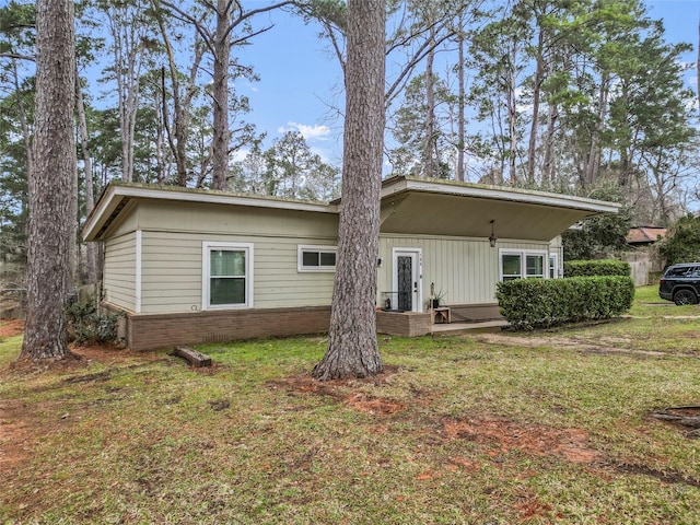 rear view of house with a yard and brick siding