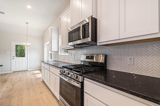 1414 Rd 66113, Dayton, TX 77535 - kitchen with appliances with stainless steel finishes, backsplash, a chandelier, lofted ceiling, and white cabinetry