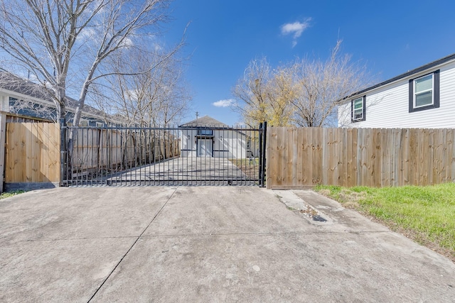 view of gate with a fenced front yard