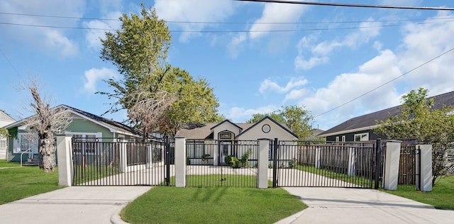 bungalow-style home with a front yard, a gate, driveway, and a fenced front yard