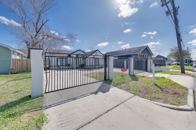 view of front of home with a fenced front yard and a gate