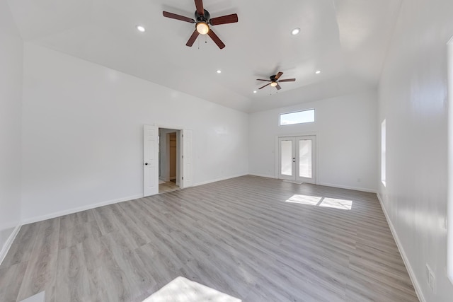 unfurnished living room featuring recessed lighting, french doors, light wood finished floors, and baseboards