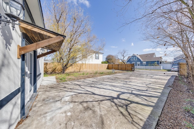 exterior space with a patio area, a fenced backyard, and a residential view