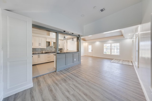 kitchen with visible vents, dark countertops, open floor plan, white cabinetry, and pendant lighting